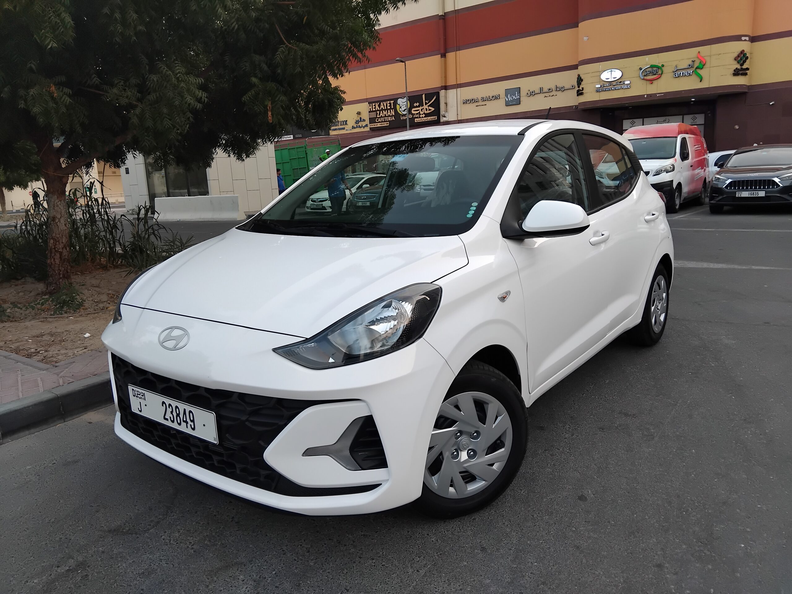 A Hyundai Grand i10 economy hatchback parked in Dubai, featuring a compact modern design, fuel-efficient petrol engine, and automatic transmission, ideal for affordable city car rental and daily driving in Dubai.